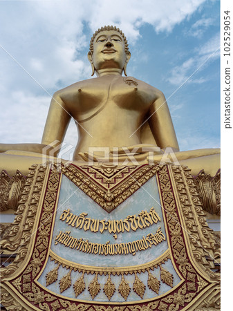The Sacred Buddha is named "Phra Buddhachinnasi" in Wat Khiriwong Temple, which has the blue sky background. The temple is located on the top of the Hill and It is worshiped by people of Pak Nam Pho. The Sacred Buddha is named "Phra Buddhachinnasi" in Wat Khiriwong Temple, which has the blue sky background. The temple is located on the top of the Hill and It is worshiped by people of Pak Nam Pho. 102529054