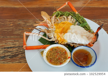 Grilled giant river shrimp or prawn with spicy seafood on wooden Grilled giant river shrimp or prawn with spicy seafood on wooden 102529954