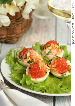 Stuffed eggs with salmon caviar Stuffed eggs with salmon caviar 102530479