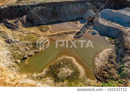 Partially flooded gravel pit from the air 102532712