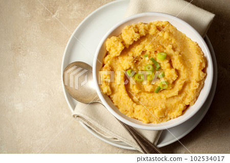 Root mash. Root vegetables mashed in a bowl. Garnished with oil and herbs. Root mash. Root vegetables mashed in a bowl. Garnished with oil and herbs. 102534017