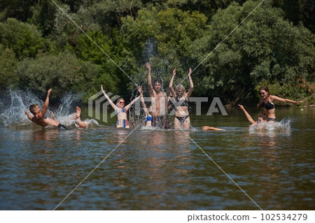 Group of young people fun on the beach, river water Group of young people fun on the beach, river water 102534279