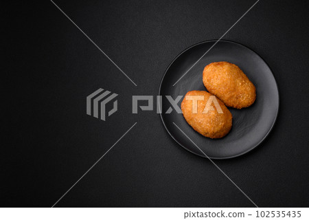 Delicious baked cutlet breaded with spices, salt and herbs Delicious baked cutlet breaded with spices, salt and herbs 102535435
