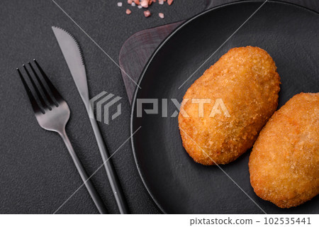 Delicious baked cutlet breaded with spices, salt and herbs 102535441