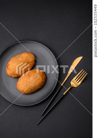 Delicious baked cutlet breaded with spices, salt and herbs 102535449