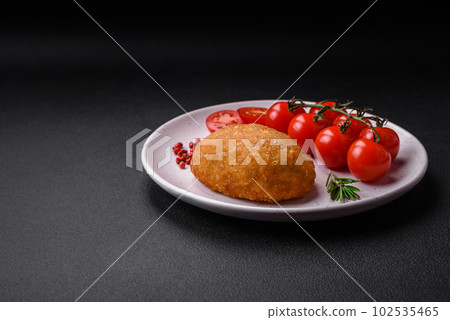 Delicious baked cutlet breaded with spices, salt and herbs Delicious baked cutlet breaded with spices, salt and herbs 102535465