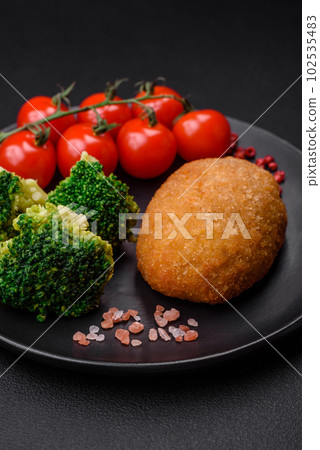 Delicious baked cutlet breaded with spices, salt and herbs Delicious baked cutlet breaded with spices, salt and herbs 102535483