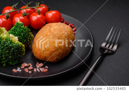Delicious baked cutlet breaded with spices, salt and herbs 102535485