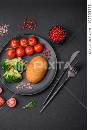 Delicious baked cutlet breaded with spices, salt and herbs 102535488