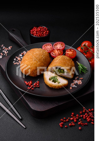 Delicious baked cutlet breaded with spices, salt and herbs Delicious baked cutlet breaded with spices, salt and herbs 102535500