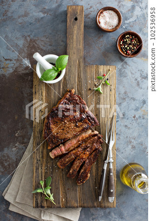 Ribeye steak on a cutting board top view 102536958