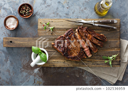 Ribeye steak on a cutting board top view Ribeye steak on a cutting board top view 102536959