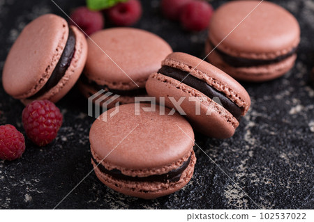 Chocolate and raspberry french macarons with ganache filling 102537022