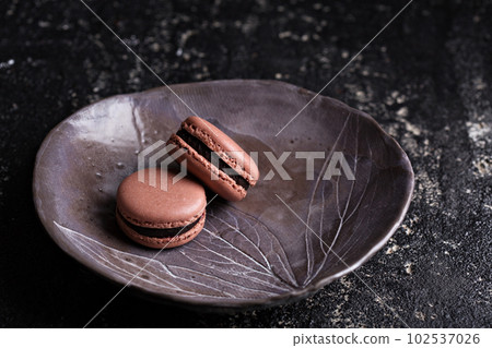 Chocolate french macarons with ganache filling 102537026
