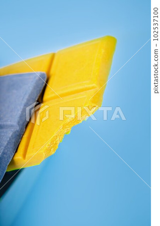 Lemon ginger yellow chocolate and blue chocolate with spirulina on a blue background 102537100