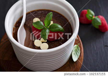 Chocolate pudding with raspberries and basil 102537155