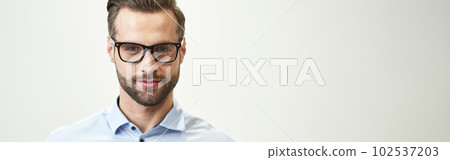 Confident handsome man with gadget on white background 102537203