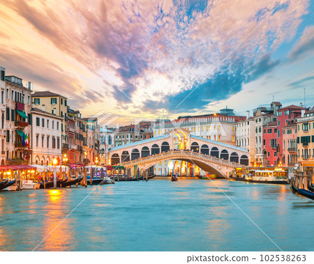 Amazing sunset and evening cityscape of Venice with famous Canal Grande and Rialto Bridge Amazing sunset and evening cityscape of Venice with famous Canal Grande and Rialto Bridge 102538263
