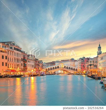 Stunning sunset and evening cityscape of Venice with famous Canal Grande and Rialto Bridge 102538264