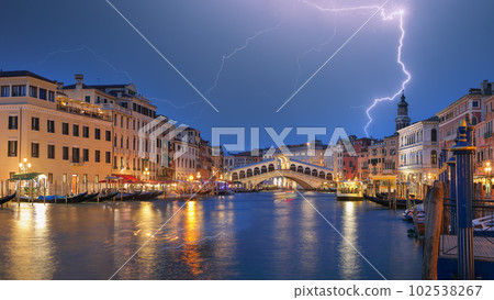 Stunning lightning at night sky over city of f Venice with famous Canal Grande and Rialto Bridge 102538267