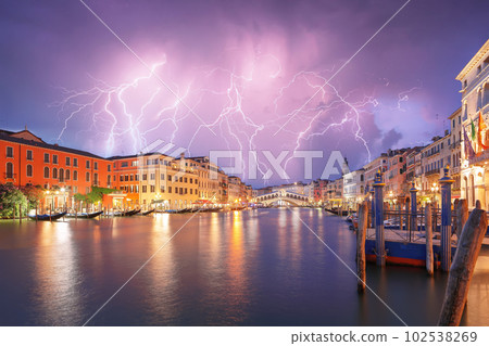 Stunning lightning at night sky over city of f Venice with famous Canal Grande and Rialto Bridge 102538269