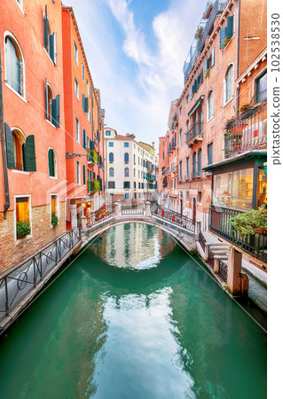 Fabulous cityscape of Venice with narrow canals, boats and gondolas and bridges with traditional buildings Fabulous cityscape of Venice with narrow canals, boats and gondolas and bridges with traditional buildings 102538530