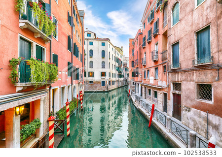Gorgeous cityscape of Venice with narrow canals, boats and gondolas and bridges with traditional buildings 102538533