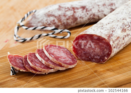 Spiced spanish longaniza sausages at wooden background 102544166