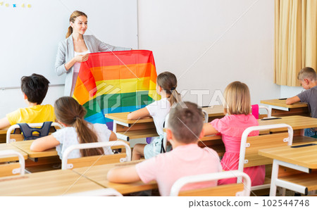 Female teacher discussing with preteen children about LGBT 102544748