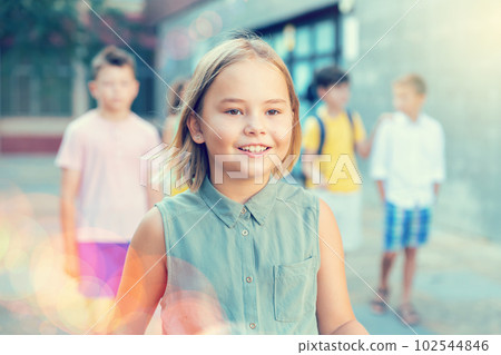 Joyful preteen girl walking along city street on summer day 102544846