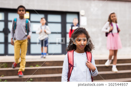 African american preteen girl walking to school on autumn day African american preteen girl walking to school on autumn day 102544937