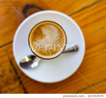 Freshly prepared cortado coffee in glass 102544970
