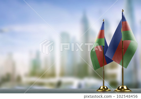 Small flags of the New Caledonia on an abstract blurry background Small flags of the New Caledonia on an abstract blurry background 102548456