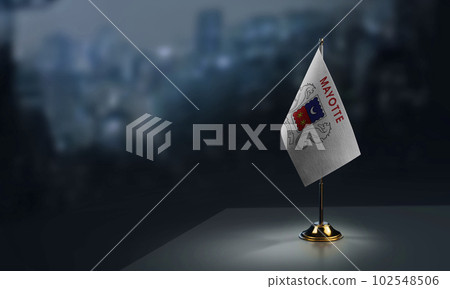 A small Mayotte flag on an abstract blurry background A small Mayotte flag on an abstract blurry background 102548506