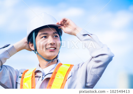 Young male engineer in helmet 102549413