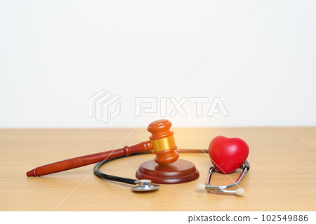 Gavel and stethoscope on table. Medical and Health Law, legal of medical malpractice concept 102549886