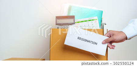 Resignation, Layoff, Unemployment, Dismiss, Job quit, Jobless and Farewell concept. Businessman holding letter of Resign contract with documents cardboard box at office Resignation, Layoff, Unemployment, Dismiss, Job quit, Jobless and Farewell concept. Businessman holding letter of Resign contract with documents cardboard box at office 102550124