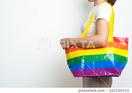 LGBT pride month concept or LGBTQ+ or LGBTQIA+ woman with Eco friendly bag with rainbow color LGBT pride month concept or LGBTQ+ or LGBTQIA+ woman with Eco friendly bag with rainbow color 102550533