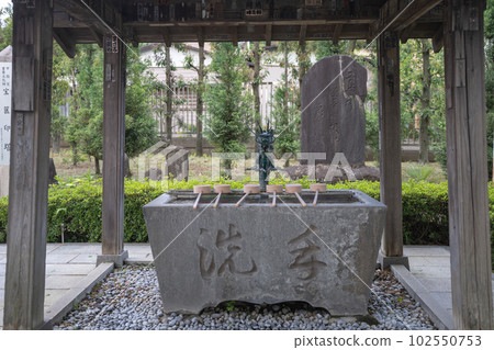 Temple chozuya and stone monument 102550753
