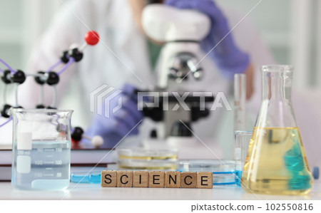 Word science collected with wooden cubes on laboratory table 102550816