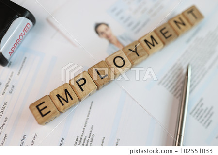Word employment collected with wooden cubes, pen and stamp approved on employee cv Word employment collected with wooden cubes, pen and stamp approved on employee cv 102551033