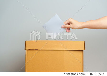 Voting and Democracy concept. Man hand putting ballot in election box, Democracy referendum for government, President and Prime Minister Vote Voting and Democracy concept. Man hand putting ballot in election box, Democracy referendum for government, President and Prime Minister Vote 102551544