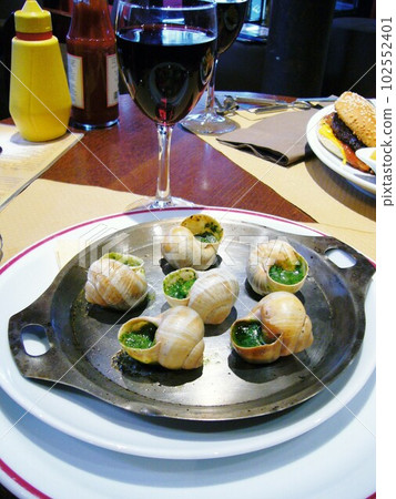 Have escargot and wine at a cafe in Paris Have escargot and wine at a cafe in Paris 102552401