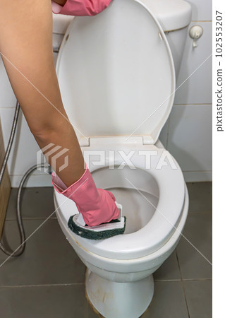 Woman cleaning toilet Woman cleaning toilet 102553207