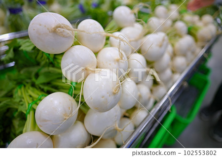 Fresh vegetables (turnips) stacked in a wagon Fresh vegetables (turnips) stacked in a wagon 102553802