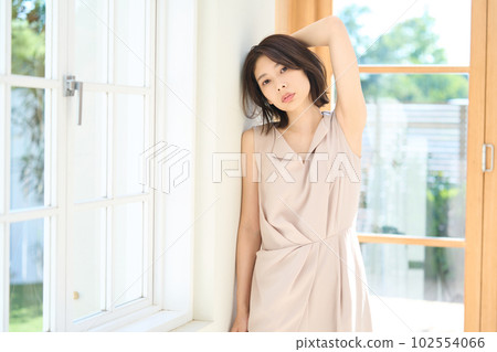 A young woman at the window A young woman at the window 102554066