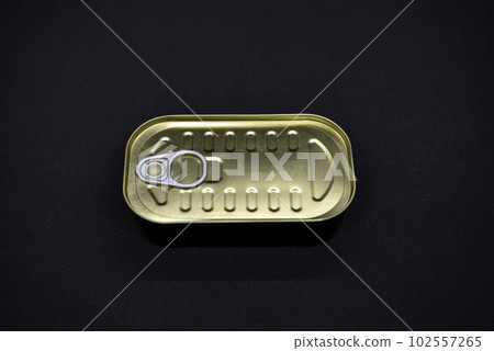 Tin can on a black background. An iron can of canned food. Tin can on a black background. An iron can of canned food. 102557265