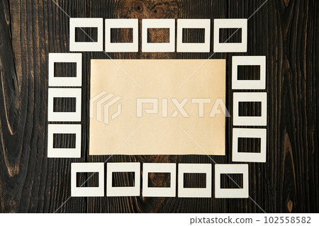 Blank craft paper mock-up with copy space on dark wooden background. Blank craft paper mock-up with copy space on dark wooden background. 102558582