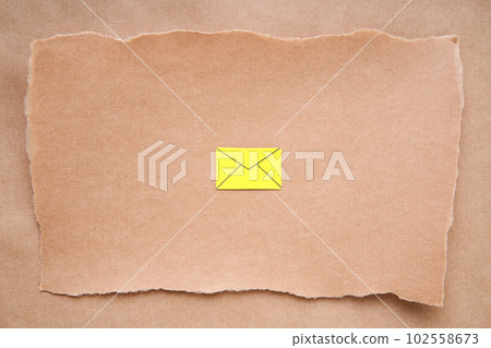 Craft postcard with yellow email icon, paper art style. Greeting card, letter, invitation mockup over grunge paper background 102558673