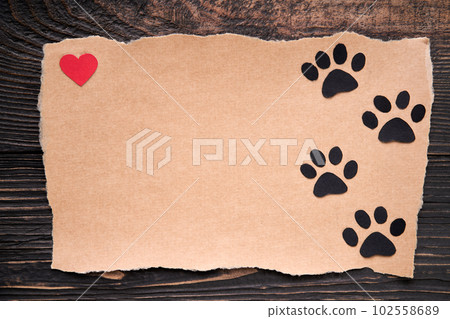 Postcard with paw foot trail icon and red heart, paper art style. Animal love concept, greeting card, invitation mockup Postcard with paw foot trail icon and red heart, paper art style. Animal love concept, greeting card, invitation mockup 102558689